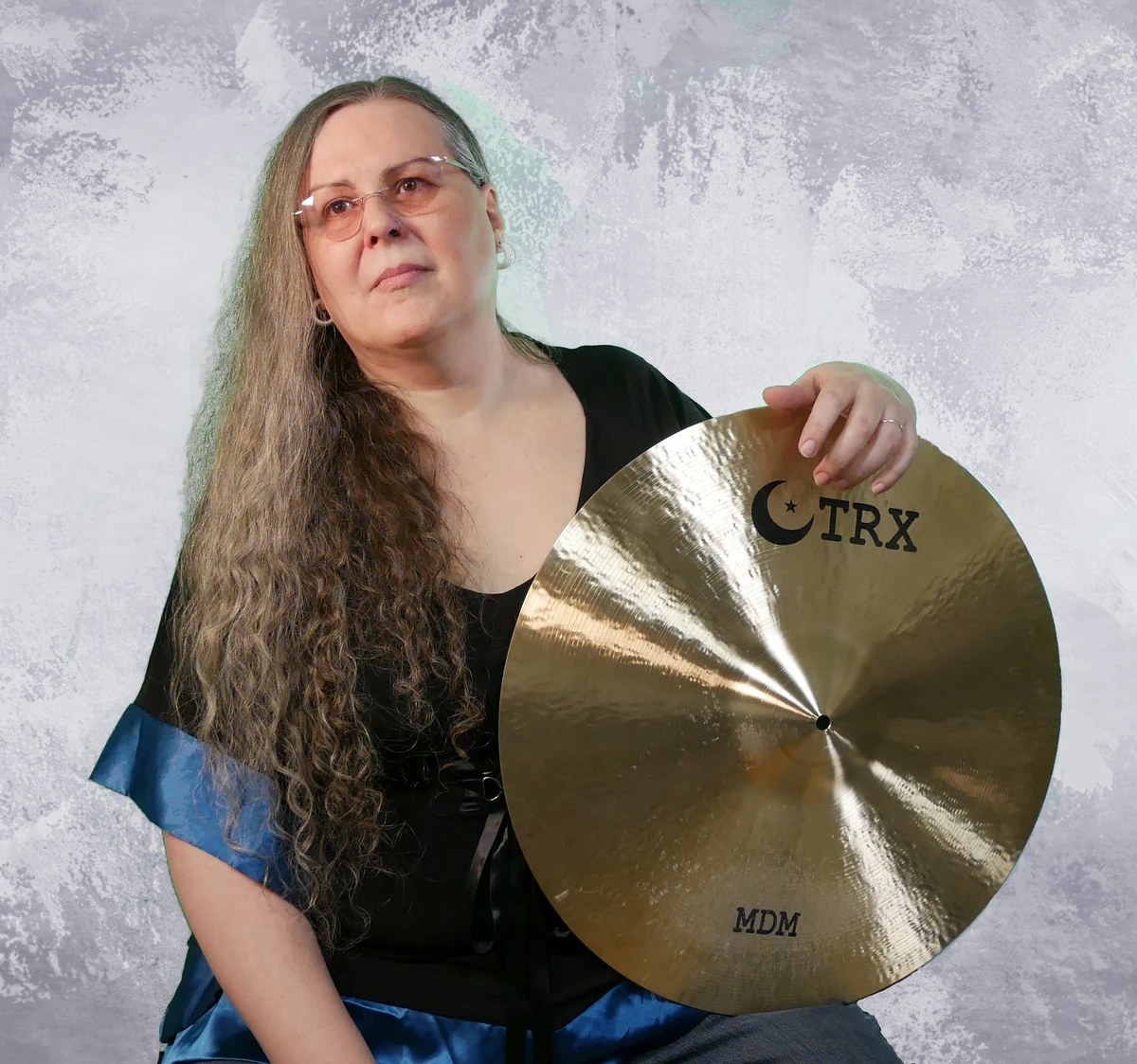 Penny Larson holding a TRX cymbal